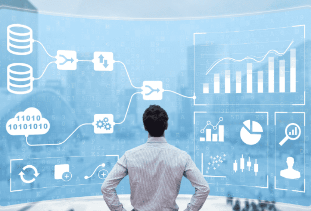 Person with back to camera stands before a large blue data dashboard showing charts, graphs, and data icons.