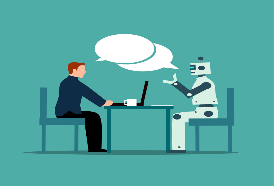 Man and friendly robot sit across from each other at a table, chatting with speech bubbles above their heads.