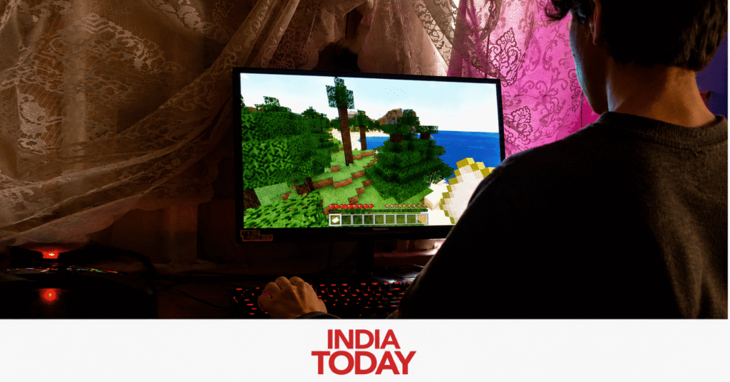 Person playing game on a desktop computer in a dimly lit room with lace curtains and a gaming setup, viewed from behind.